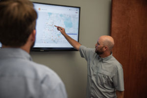 A couple of Whitney Logistics employees map out a bulk materials hauling route for an upcoming job.