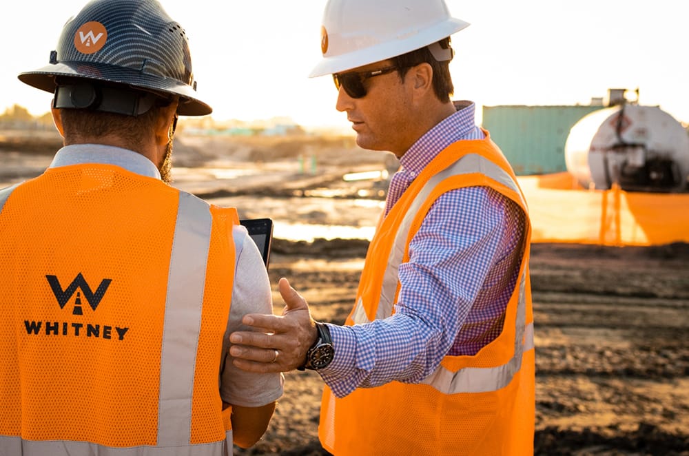 Employees discussing site work
